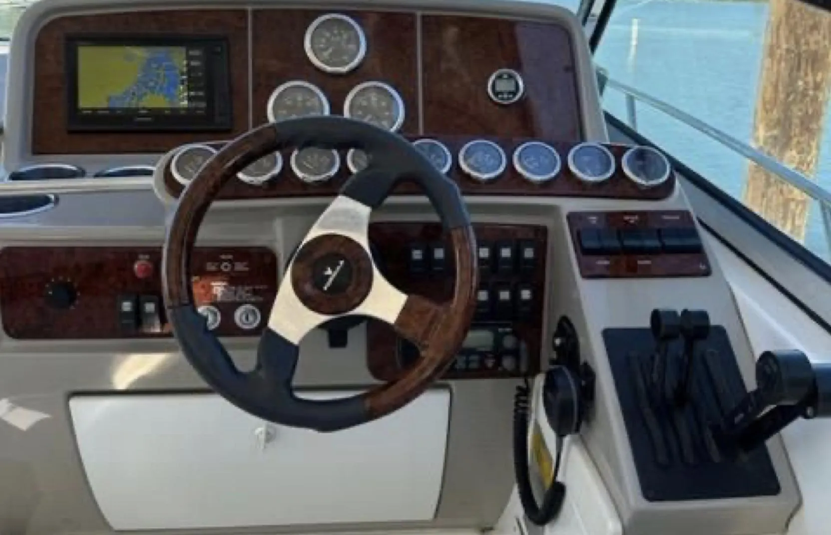 2003 Formula 37 PC boat dashboard with steering wheel and navigation controls.