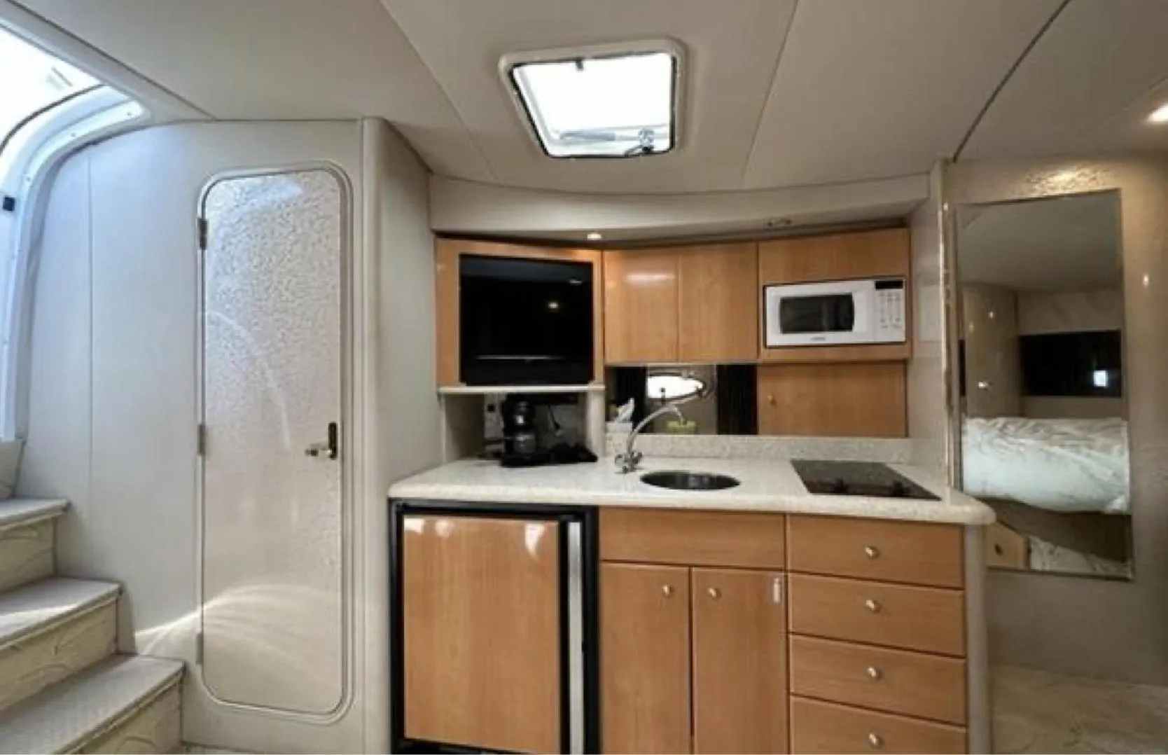 Interior of 2003 Formula 37 PC yacht with kitchenette, microwave, and compact fridge.