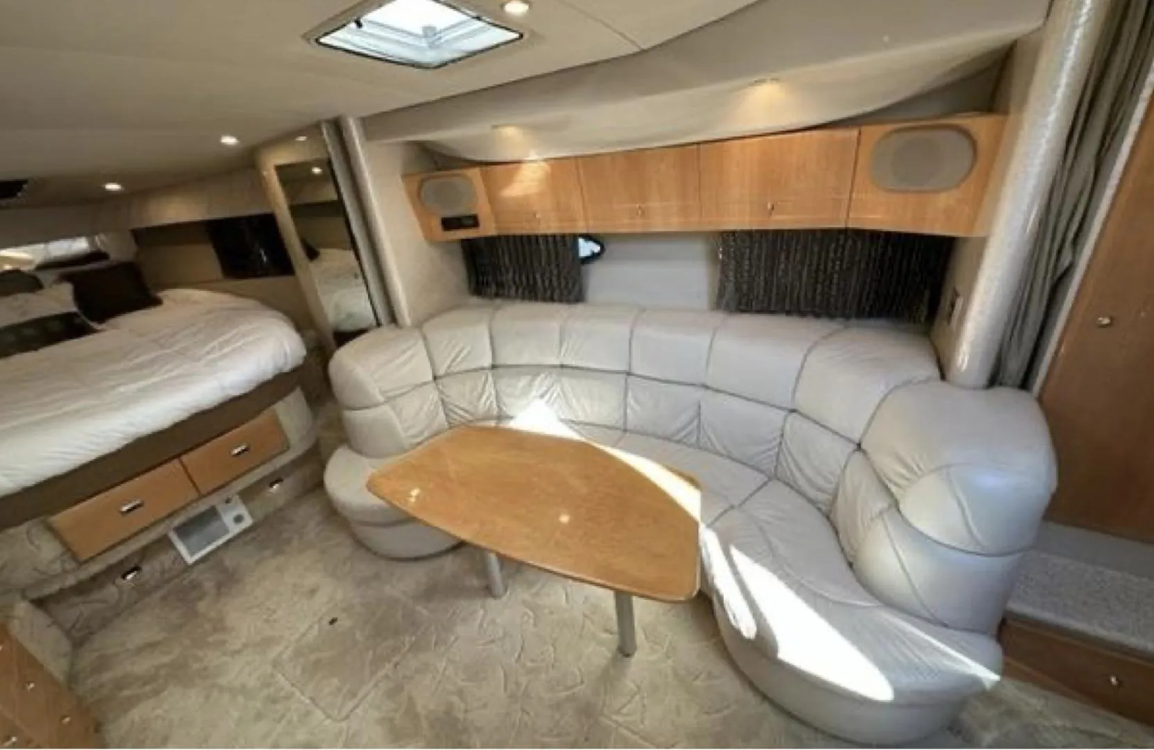 2003 Formula 37 PC yacht interior with leather seating and wooden table.