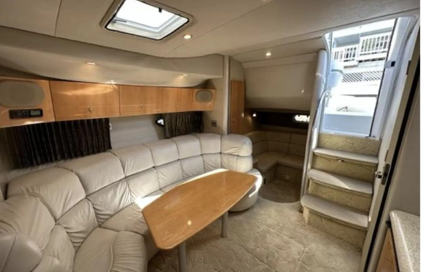 Luxurious interior of a 2003 Formula 37 PC yacht with plush seating and wooden accents.