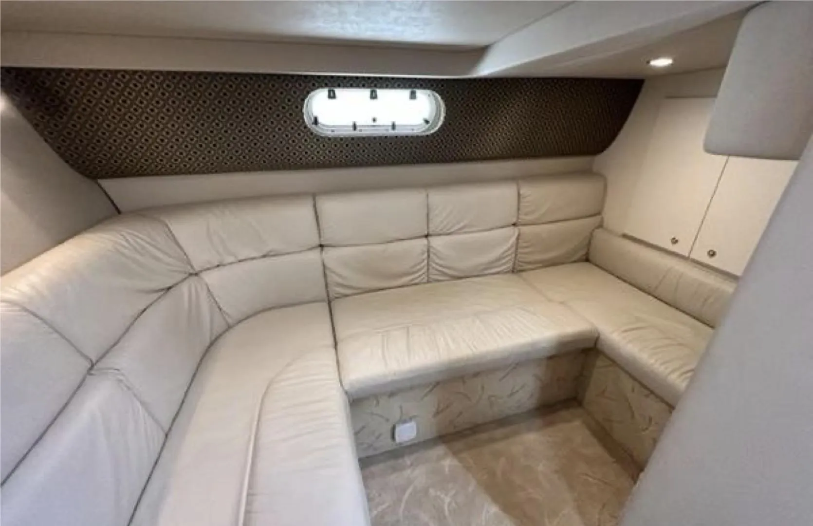 Luxurious interior of 2003 Formula 37 PC yacht with plush beige seating.