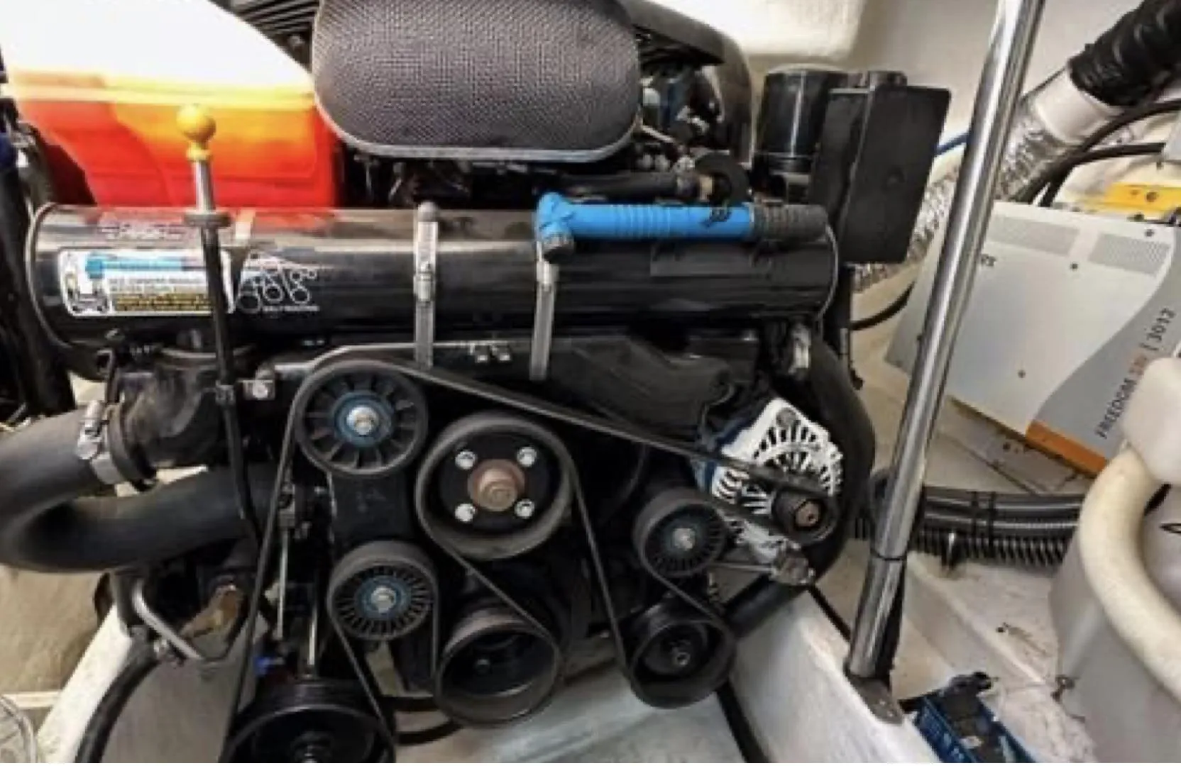 Engine compartment of a 2003 Formula 37 PC boat, showcasing belts and components.