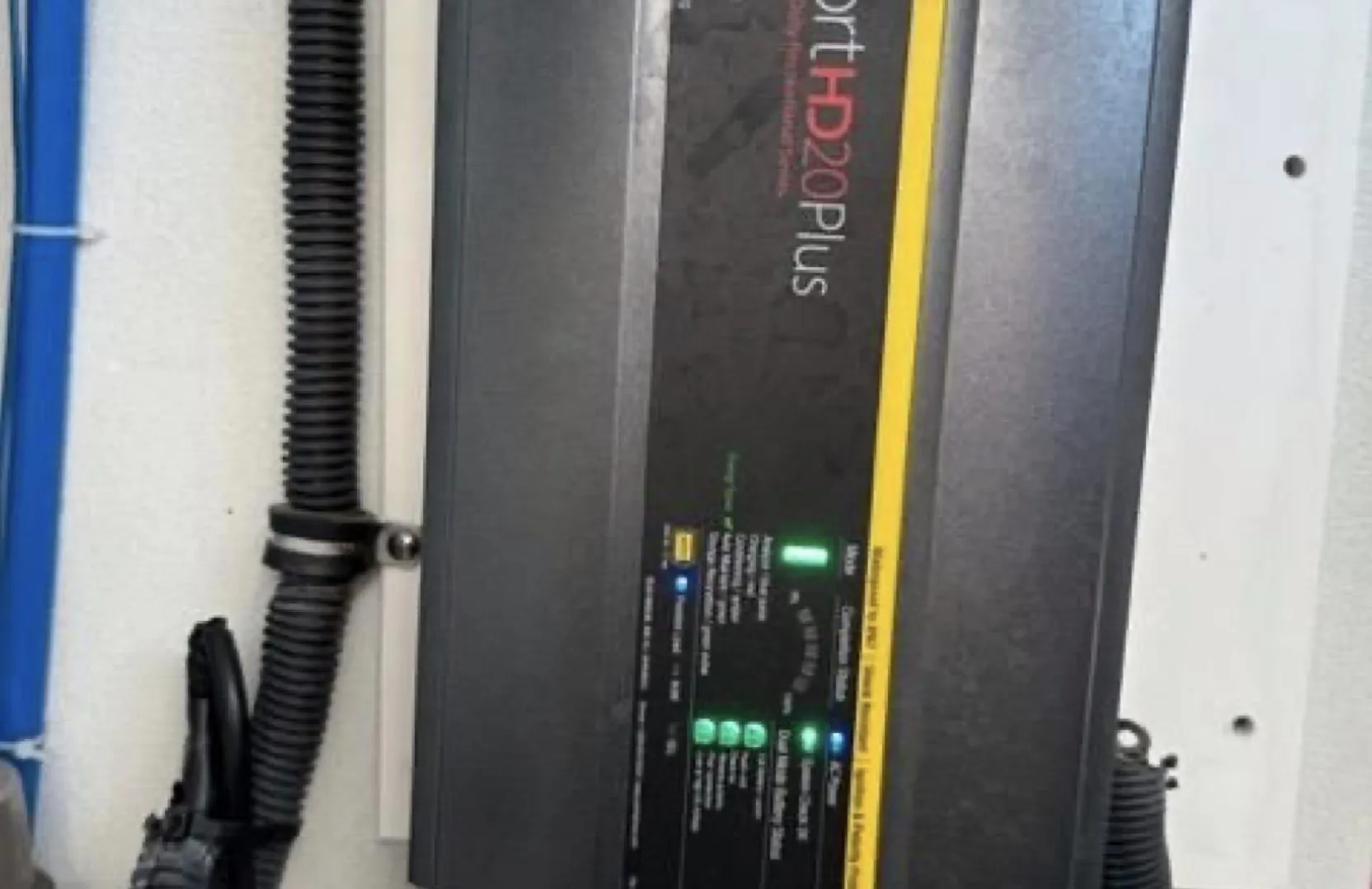 Battery charger mounted on a wall, labeled "ProSport HD20 Plus," in a 2003 Formula 37 PC.