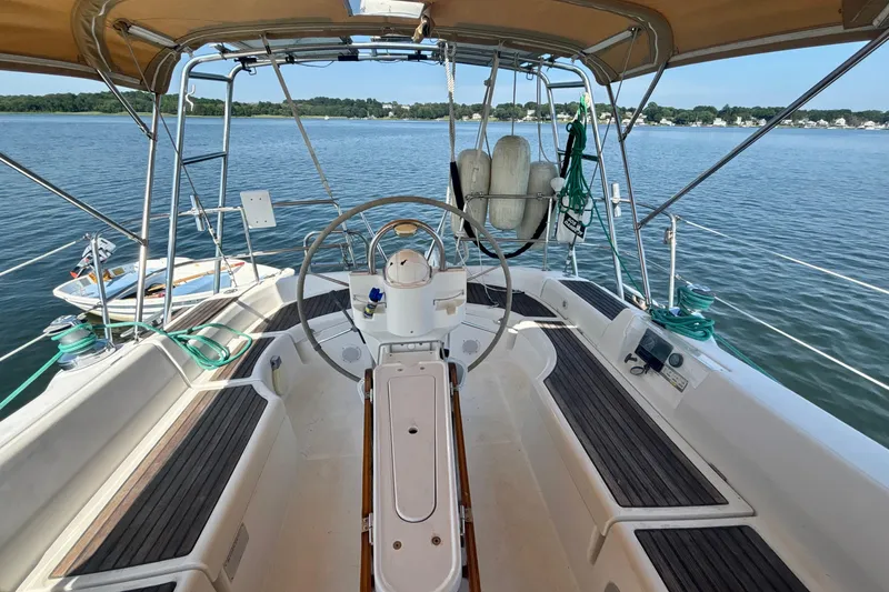 Table 4 Two Yacht Photos Pics Cockpit view of 2004 Beneteau Oceanis 423 sailboat with steering wheel and open water backdrop.