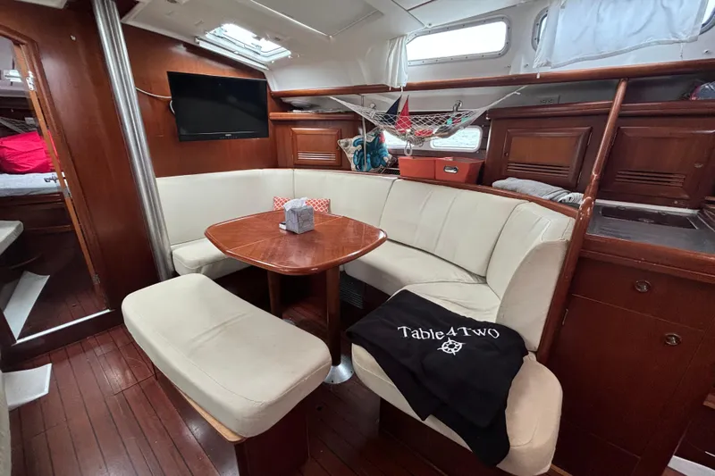 Table 4 Two Yacht Photos Pics Interior of 2004 Beneteau Oceanis 423 yacht with cozy seating and wooden finishes.