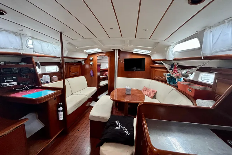 Table 4 Two Yacht Photos Pics Interior of 2004 Beneteau Oceanis 423 sailboat with cozy seating and wooden finishes.