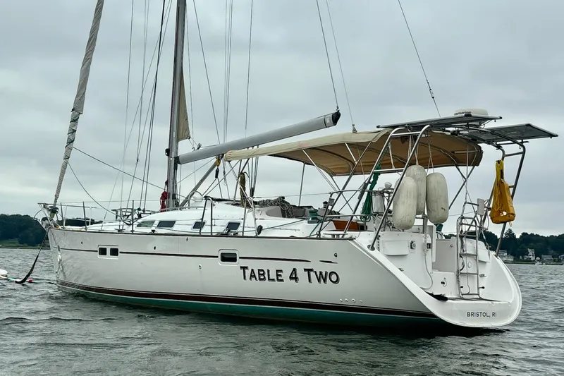 Table 4 Two Yacht Photos Pics 2004 Beneteau Oceanis 423 sailboat named "Table 4 Two" anchored on water.