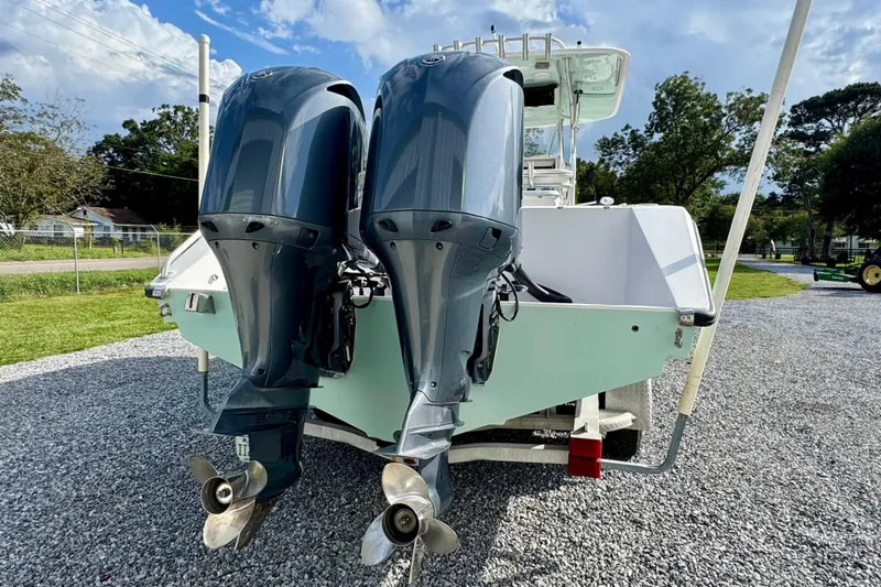  Yacht Photos Pics 2010 Venture 34 Tournament boat with dual outboard motors on gravel driveway.