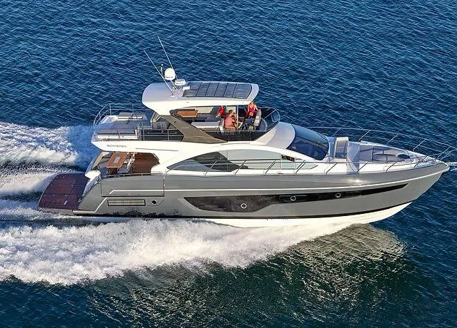  Yacht Photos Pics 2025 Schaefer 660 yacht cruising on open water, showcasing sleek design and luxury features.