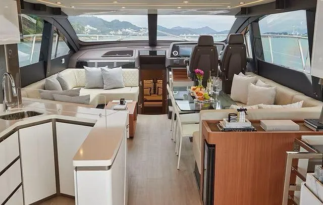 Luxurious interior of 2025 Schaefer 660 yacht with modern furnishings and scenic ocean view.