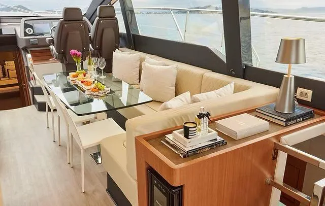  Yacht Photos Pics Luxurious interior of 2025 Schaefer 660 yacht with elegant dining area and modern decor.