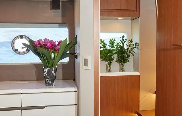  Yacht Photos Pics Luxurious Schaefer 660 yacht interior with elegant floral decor, modern cabinetry, and ocean view.