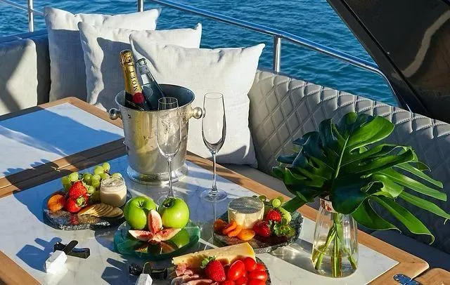  Yacht Photos Pics Luxurious yacht dining setup with champagne, fruits, and cheese on a Schaefer 660, 2025 model.