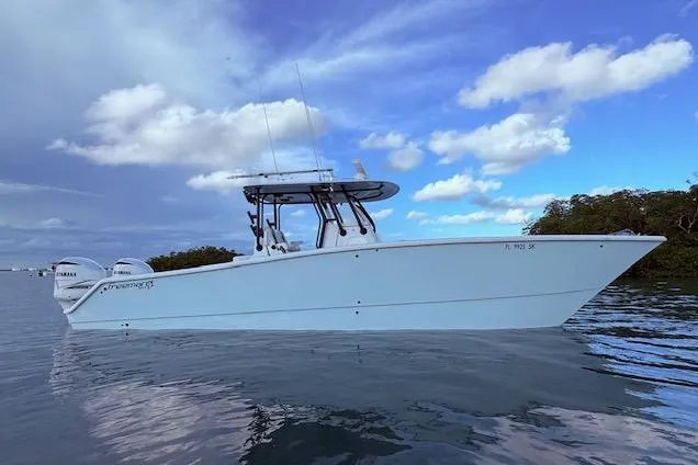  Yacht Photos Pics 2019 Freeman 34 boat on calm water under a partly cloudy sky.