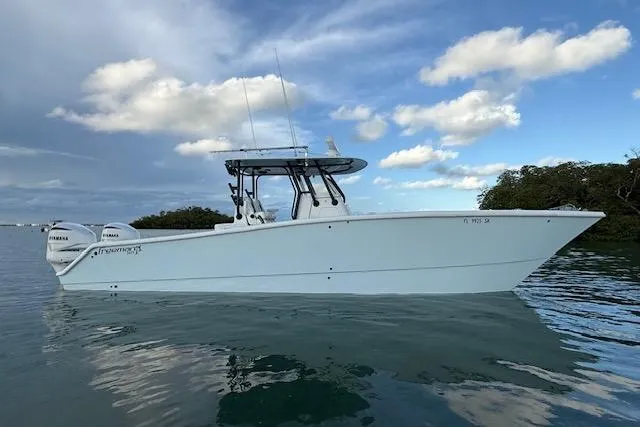  Yacht Photos Pics 2019 Freeman 34 boat on calm water under a partly cloudy sky.