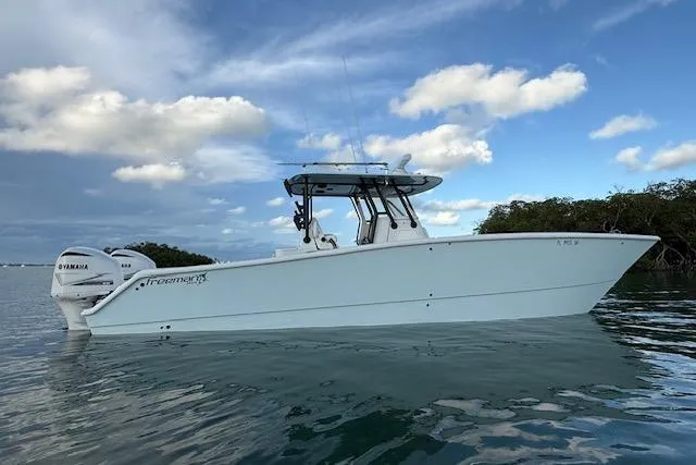  Yacht Photos Pics 2019 Freeman 34 boat with Yamaha engines on calm water under a blue sky.