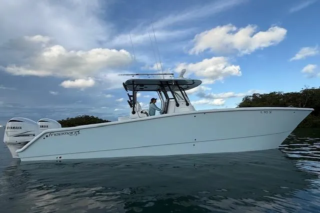  Yacht Photos Pics 2019 Freeman 34 boat on water with Yamaha engines, under a partly cloudy sky.