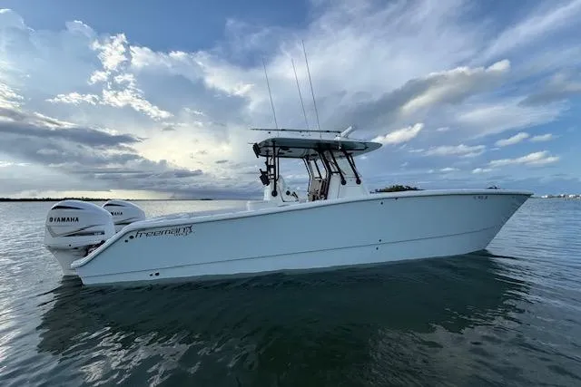  Yacht Photos Pics 2019 Freeman 34 boat on calm water under a cloudy sky.