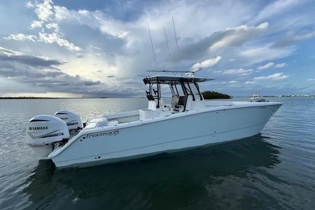  Yacht Photos Pics 2019 Freeman 34 boat with Yamaha engines on calm water under a cloudy sky.