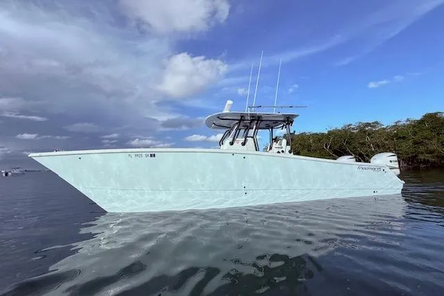  Yacht Photos Pics 2019 Freeman 34 boat on calm water under a cloudy sky.