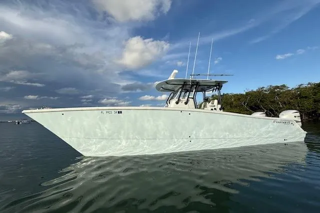  Yacht Photos Pics 2019 Freeman 34 boat on calm water under a partly cloudy sky.