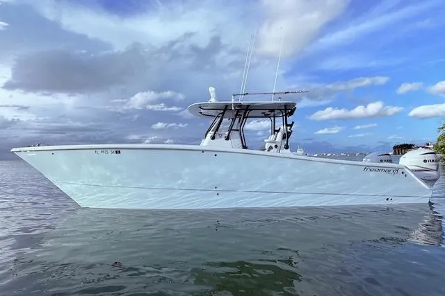  Yacht Photos Pics 2019 Freeman 34 boat on calm water under a partly cloudy sky.