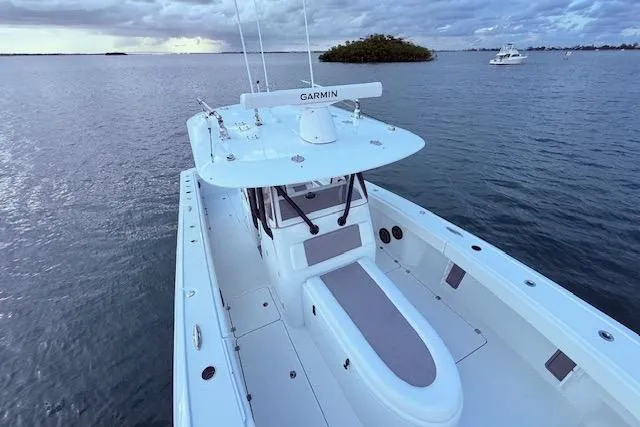  Yacht Photos Pics 2019 Freeman 34 boat on calm water, featuring Garmin equipment, under a cloudy sky.
