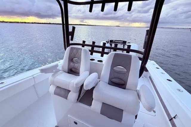  Yacht Photos Pics 2019 Freeman 34 boat interior with dual seats, overlooking calm waters at sunset.