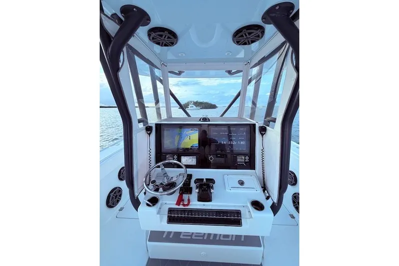  Yacht Photos Pics Freeman 34 boat cockpit with navigation screens and steering wheel, 2019 model.