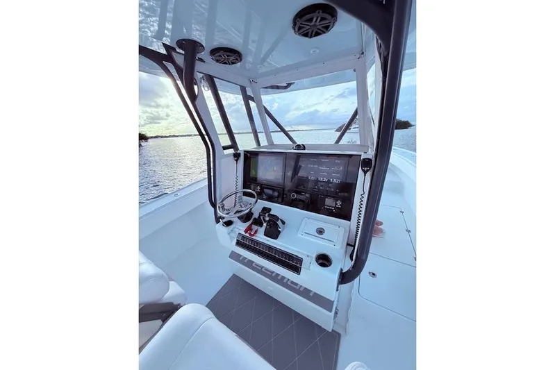  Yacht Photos Pics 2019 Freeman 34 boat cockpit with modern navigation equipment, overlooking serene water.