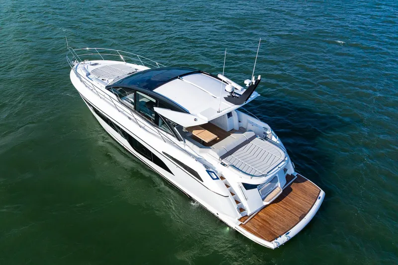 Andielaine IV Yacht Photos Pics 2021 Sunseeker 60 Evo yacht cruising on open water, aerial view.