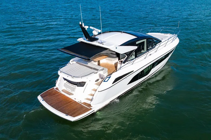 Andielaine IV Yacht Photos Pics 2021 Sunseeker 60 Evo yacht cruising on open water, rear view.