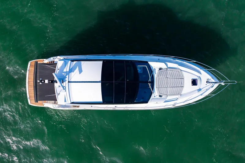Andielaine IV Yacht Photos Pics Aerial view of 2021 Sunseeker 60 Evo yacht on green water.