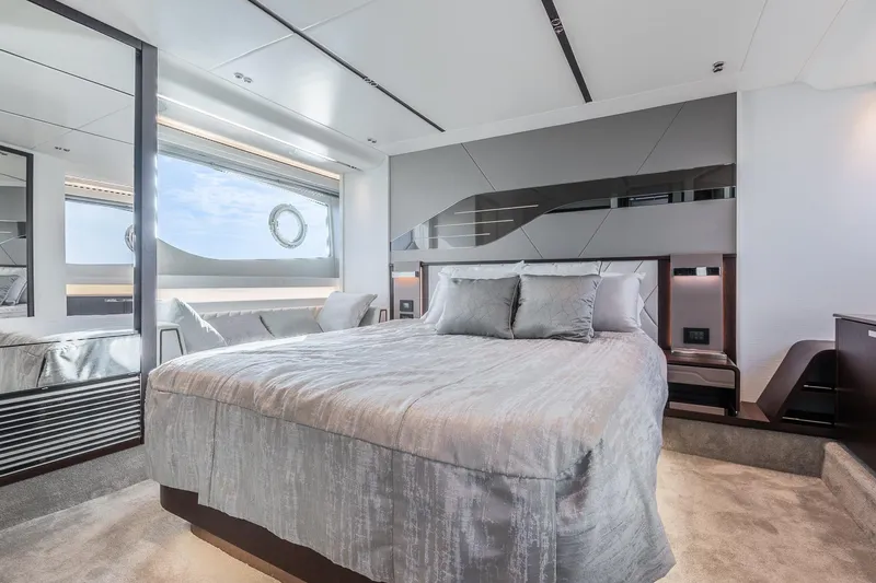 Andielaine IV Yacht Photos Pics Luxurious bedroom interior of 2021 Sunseeker 60 Evo yacht with modern design and large window.