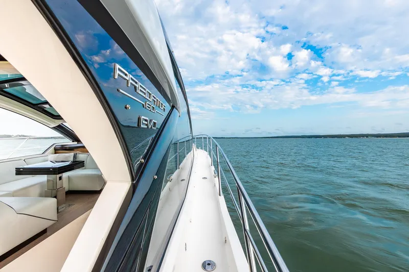 Andielaine IV Yacht Photos Pics Luxurious 2021 Sunseeker 60 Evo yacht cruising on open water under blue sky.