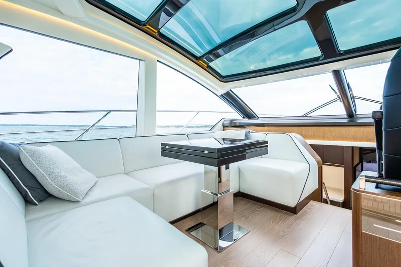 Andielaine IV Yacht Photos Pics Luxurious interior of 2021 Sunseeker 60 Evo yacht with modern seating and panoramic windows.