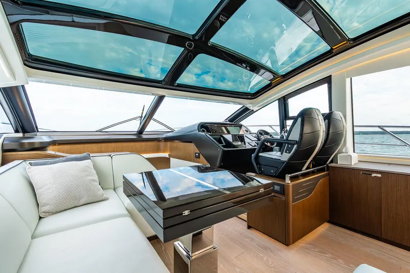 Andielaine IV Yacht Photos Pics Luxurious interior of 2021 Sunseeker 60 Evo yacht with panoramic windows and modern seating.