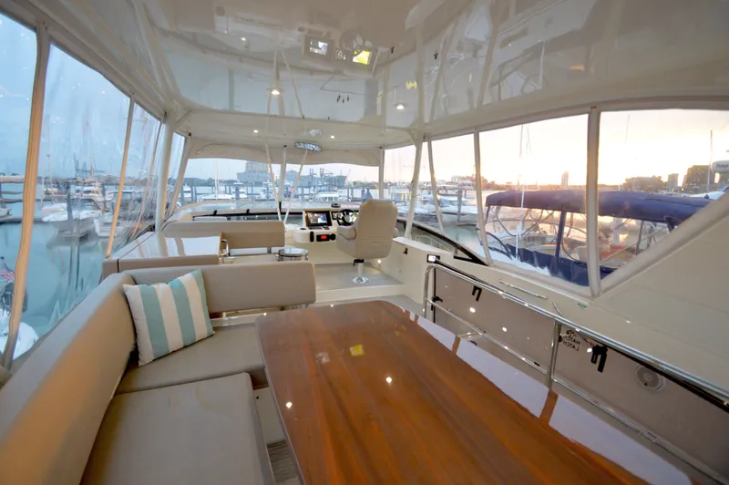 Play Craft Yacht Photos Pics Luxurious 2018 Carver C52 Flybridge interior with elegant seating and marina view.