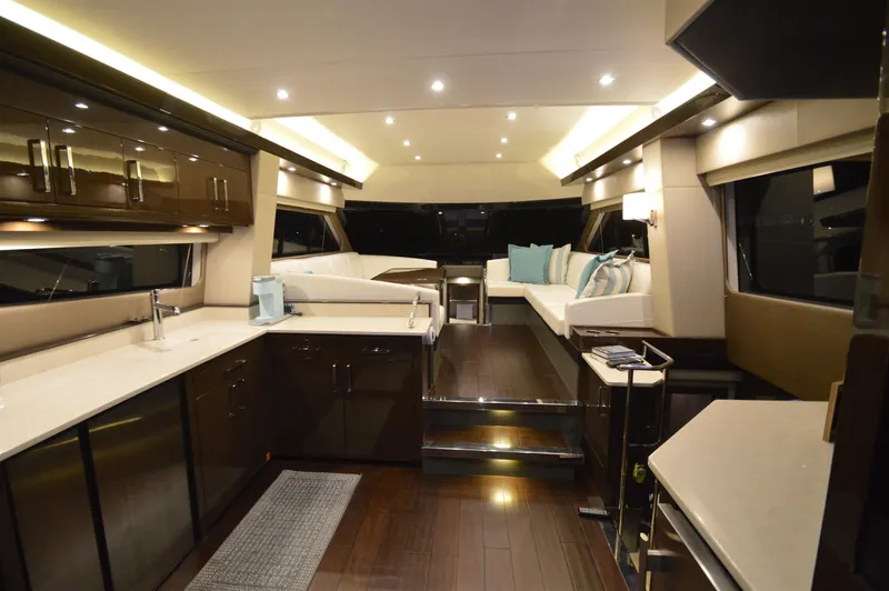 Play Craft Yacht Photos Pics Luxurious interior of 2018 Carver C52 Flybridge yacht with modern kitchen and seating area.