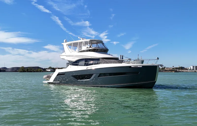 Play Craft Yacht Photos Pics 2018 Carver C52 Flybridge yacht cruising on calm waters under a clear blue sky.