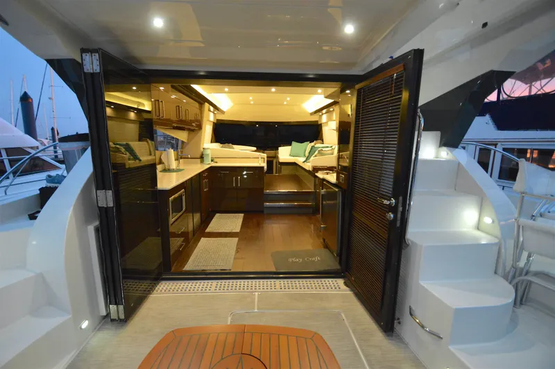 Play Craft Yacht Photos Pics Luxurious interior of 2018 Carver C52 Flybridge yacht with modern kitchen and seating area.