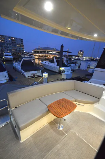 Play Craft Yacht Photos Pics Luxurious 2018 Carver C52 Flybridge yacht with elegant seating at a marina during twilight.