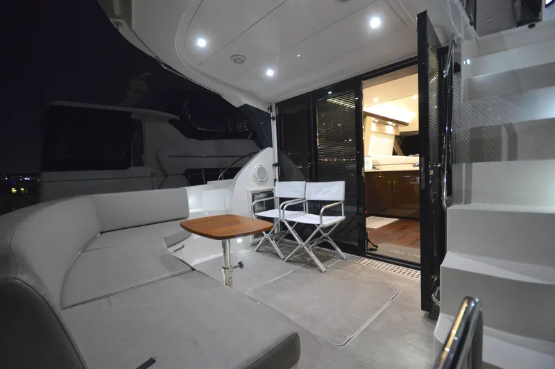 Play Craft Yacht Photos Pics Luxurious 2018 Carver C52 Flybridge yacht interior with seating and modern lighting.