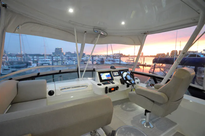 Play Craft Yacht Photos Pics Flybridge of 2018 Carver C52 yacht at sunset, featuring modern navigation controls.