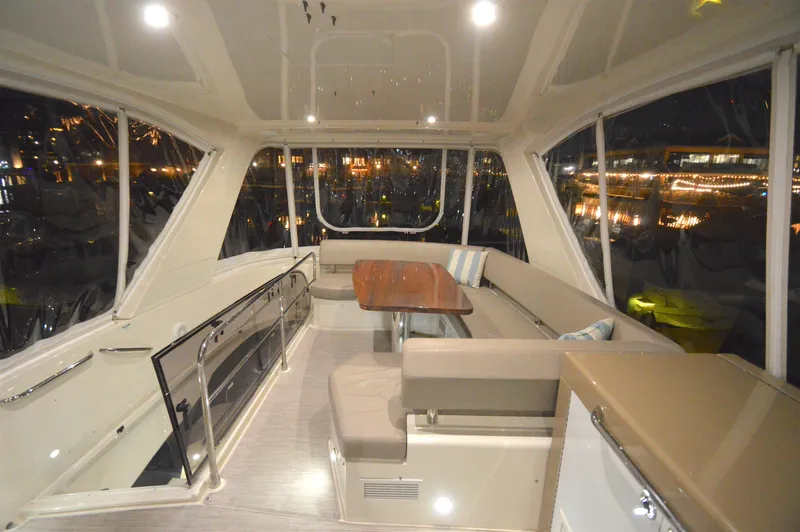Play Craft Yacht Photos Pics Luxurious interior of 2018 Carver C52 Flybridge yacht with elegant seating and table.