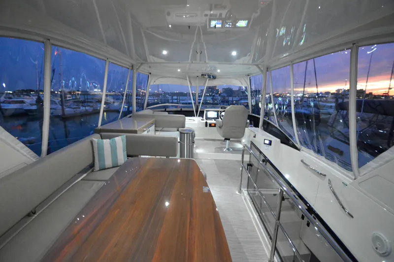 Play Craft Yacht Photos Pics Luxurious 2018 Carver C52 Flybridge interior with elegant seating and panoramic marina views.