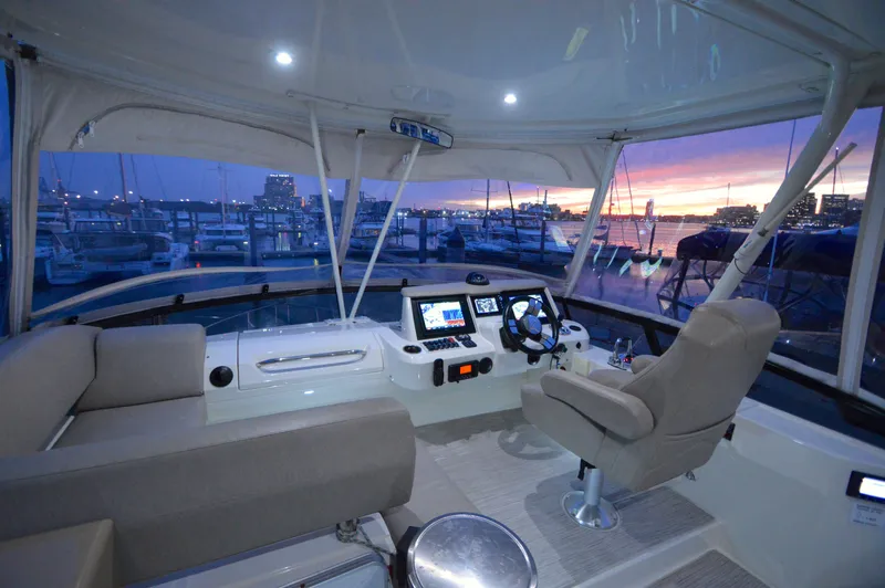Play Craft Yacht Photos Pics Luxurious 2018 Carver C52 Flybridge yacht interior at sunset, featuring modern navigation equipment.