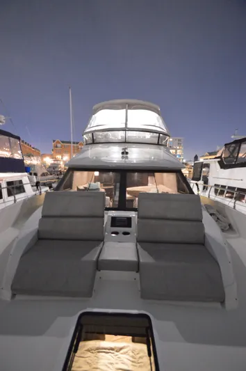 Play Craft Yacht Photos Pics 2018 Carver C52 Flybridge yacht at night, docked with illuminated interior.