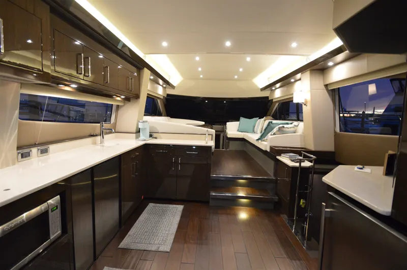 Play Craft Yacht Photos Pics Luxurious interior of 2018 Carver C52 Flybridge yacht with modern kitchen and seating area.