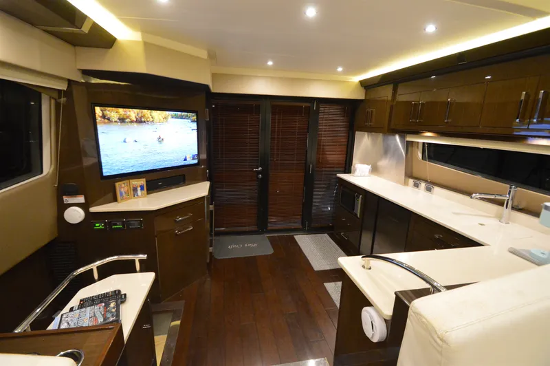 Play Craft Yacht Photos Pics Luxurious interior of 2018 Carver C52 Flybridge yacht with modern kitchen and entertainment area.